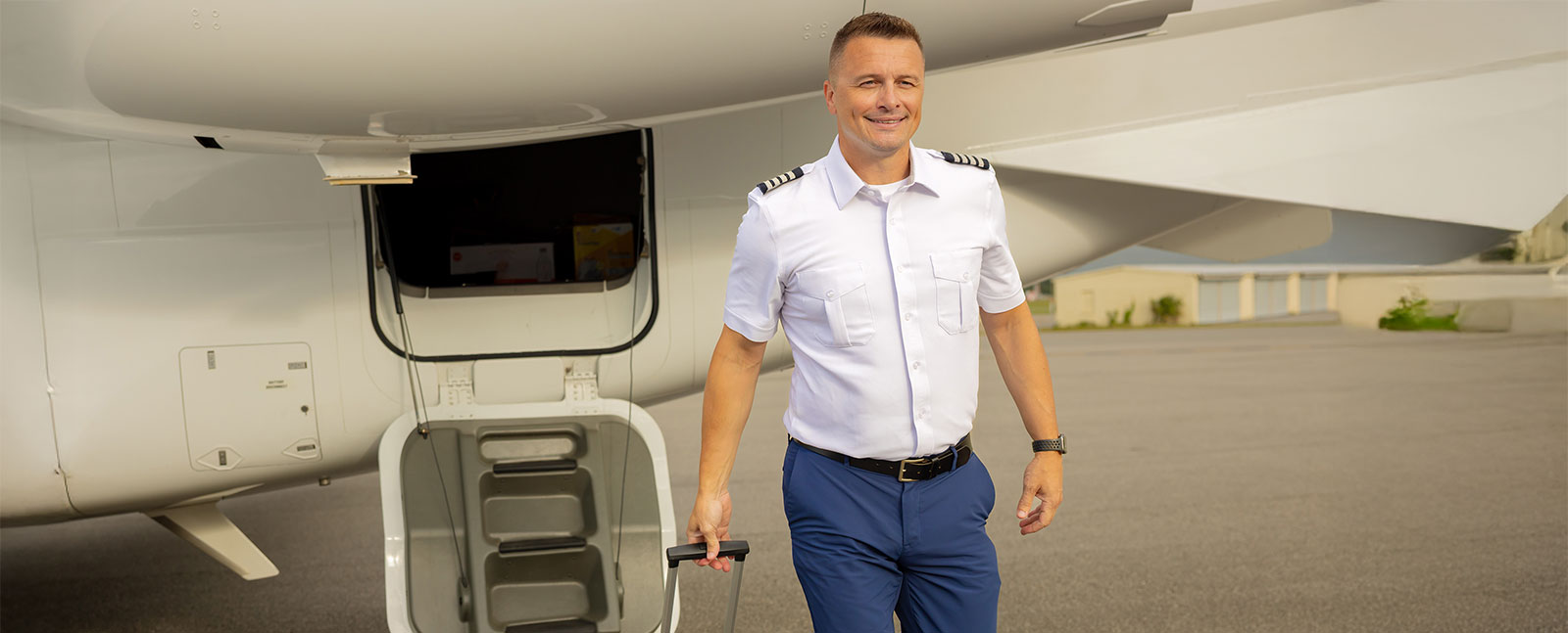 Photo of one of our compassionate pilots helping passengers with their luggage as they travel for medical or personal purposes.